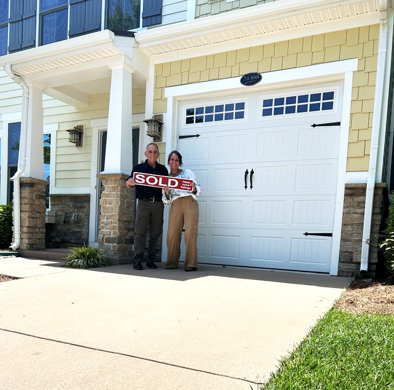 Michael with a seller client holding a sold sign